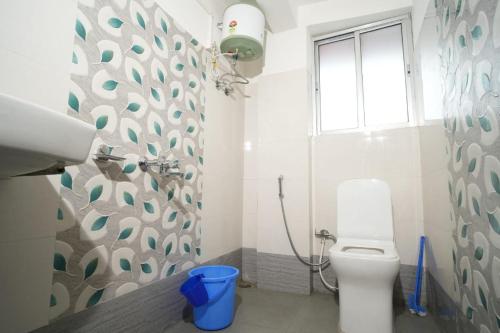 a bathroom with a toilet and a window at Himavati Retreat in Darjeeling