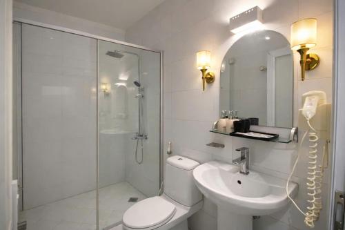 a bathroom with a toilet and a sink and a shower at Eco Nest Hotel 6 Đình Ngang in Hanoi