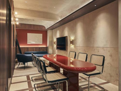 a conference room with a red table and chairs at illi Noa Hamamatsucho in Tokyo