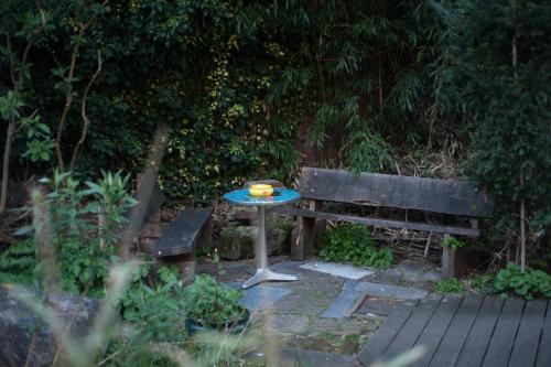 a table with a bowl on it next to a bench at Strowis Hostel in Utrecht
