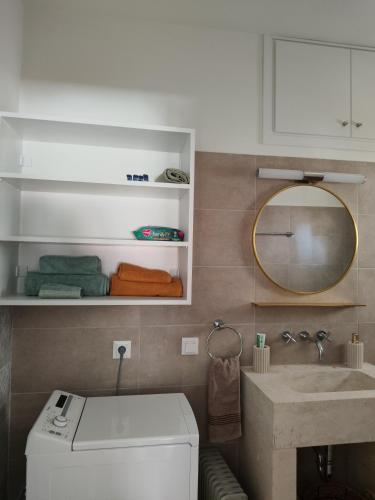 a bathroom with a sink and a mirror at NMD house in Ermioni