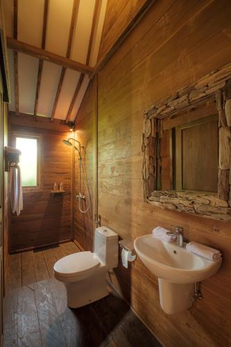 a bathroom with a toilet and a sink at Jero Jawi Javanese Villa in Lebih
