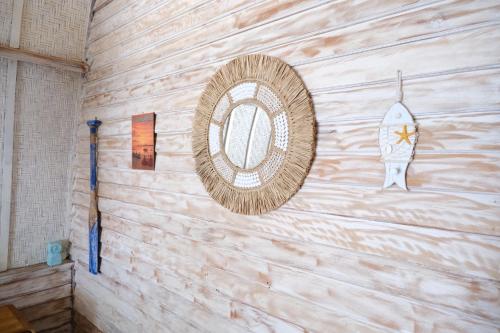 a wall with a mirror and a rocket on it at Jungle Gili Air in Gili Islands