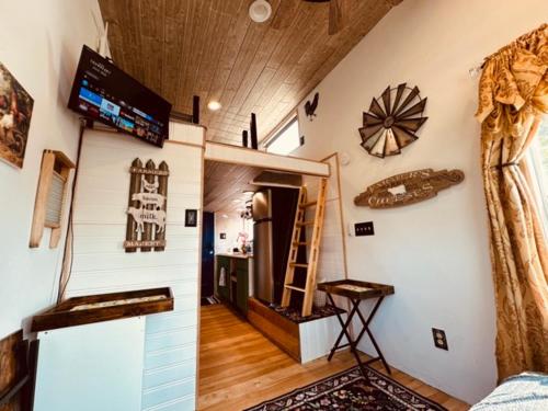 a room with a room with a shelf and a ladder at Tiny House Farm Stay Pets Welcome in Battle Ground