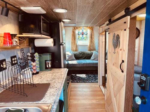 a kitchen and living room in a tiny house at Tiny House Farm Stay Pets Welcome in Battle Ground