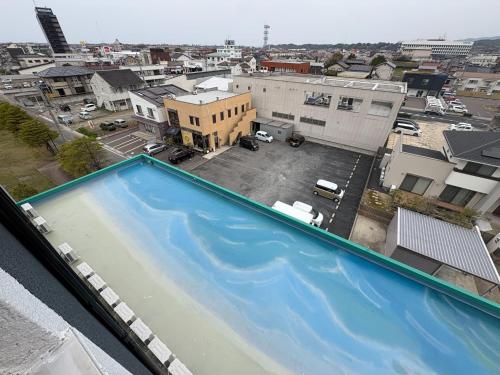an empty swimming pool on top of a city at Peace INN Masuda-ekikita in Masuda