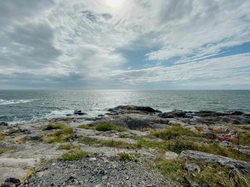 a rocky shore with the ocean in the background at Historic Cabin By Landsort Lighthouse in Nynäshamn