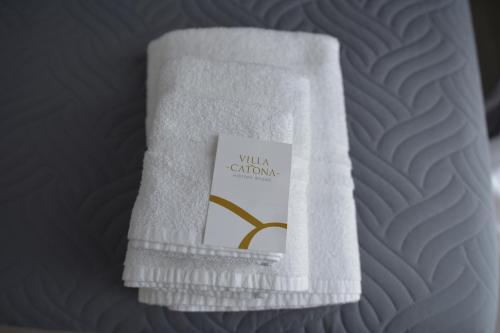a white towel with a book on it on a bed at Villa Catona Trigoria in Rome