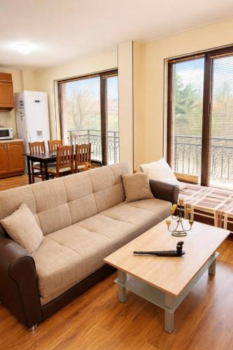 a living room with a couch and a table at Pomorie Sea&History Residence in Pomorie