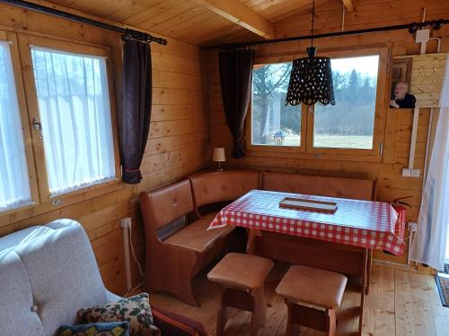 a room with a table and chairs in a cabin at Chalet Glamping in Myza Igaste