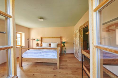 a bedroom with a bed with white sheets at A Historic Gem With Wellness Comfort in Übersee