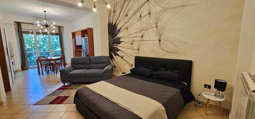 a bedroom with a bed and a couch and a chair at Viale Umberto Apartments in Sassari