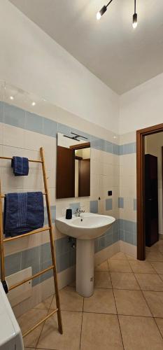 a bathroom with a sink and a mirror at Viale Umberto Apartments in Sassari