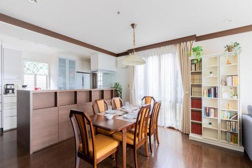 a kitchen and dining room with a table and chairs at Private Inn Ray in Nara
