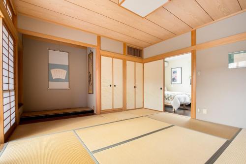 a living room with a wooden ceiling at Private Inn Ray in Nara