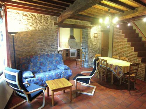 a living room with a couch and a table at Riverside Retreat Viroinval in Treignes