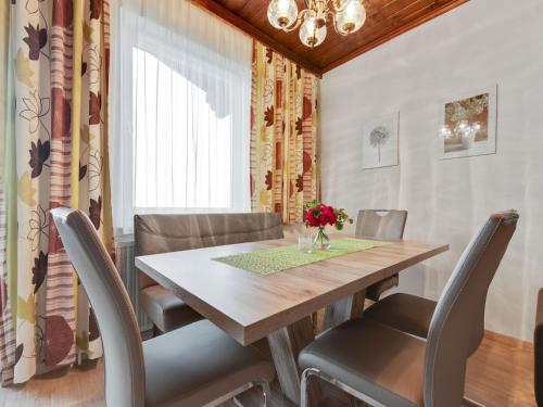 a dining room with a wooden table and chairs at Apartment in Afritz near Ski Resorts in Afritz