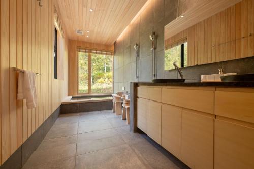 a bathroom with a sink and a large window at Ro-An 炉庵 in Kutchan