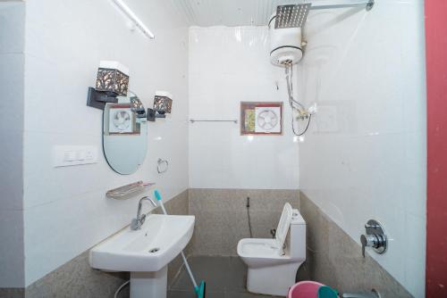 a bathroom with a sink and a toilet at Forest Rest House Barot in Barot 