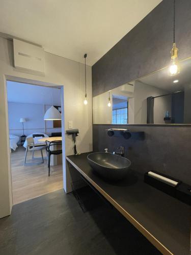 a bathroom with a sink and a large mirror at 古街のアトリエ in Utazu