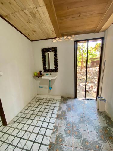 a bathroom with a sink and a mirror at Teak Soul Home in Ban Na Toeng Nai