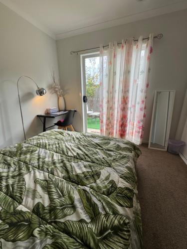 a bedroom with a bed and a window at Quiet and Cozy Room in Geelong