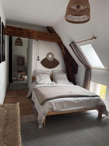 a bedroom with a large bed in a room at La Cuvée , duplex à Gevrey Chambertin. in Gevrey-Chambertin