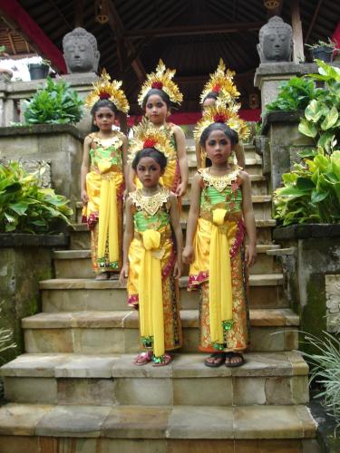 three little girls standing on some steps at Tamukami Hotel in Sanur