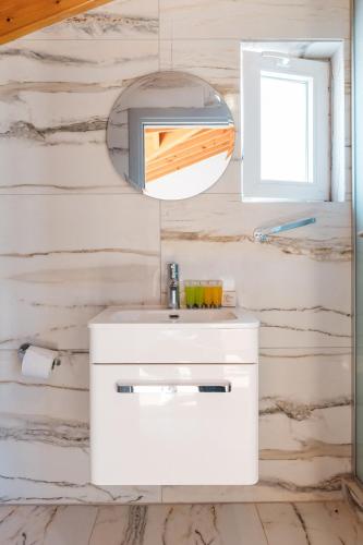 a bathroom with a white sink and a mirror at Modern Studio Loft in Central Larnaca with WiFi in Larnaca