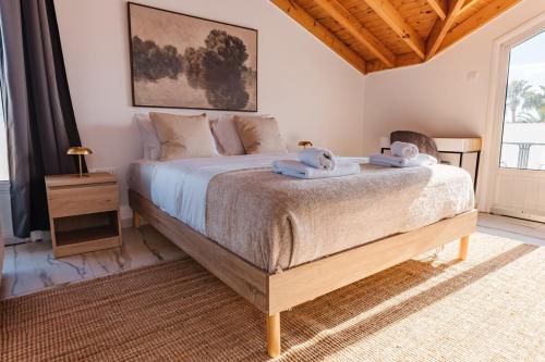 a bedroom with a large bed with towels on it at Modern Studio Loft in Central Larnaca with WiFi in Larnaca