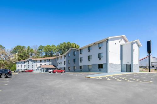 a building in a parking lot next to a parking lot at Super 8 by Wyndham Homewood Birmingham Area in Birmingham