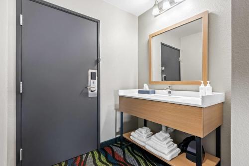 a bathroom with a sink and a mirror at Super 8 by Wyndham Farmington in Farmington