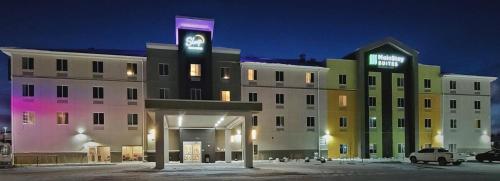 a large building with a sign on top of it at MainStay Suites Great Falls Airport in Great Falls