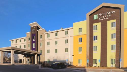 a hotel with a car parked in front of it at MainStay Suites Great Falls Airport in Great Falls