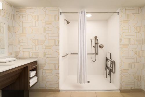 a bathroom with a shower and a sink at Home2 Suites By Hilton Jacksonville Airport in Jacksonville