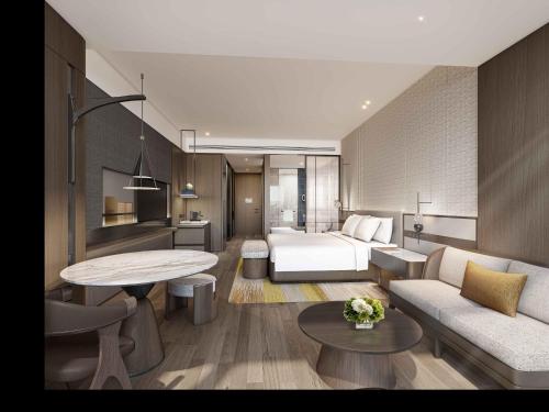 a hotel room with a bed and a living room at Hilton Quzhou in Quzhou