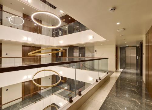 a lobby with glass shelves and a staircase at The Qubice Hotel, Kolhapur in Kolhapur