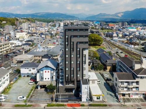 an aerial view of a city with a tall building at THE STILL HOTEL - Opening April 3, 2026 in Ozu