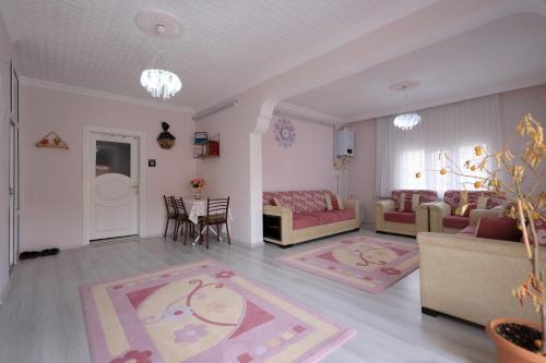 a living room with couches and a table and chairs at Ipek Esintisi House in Nevşehir