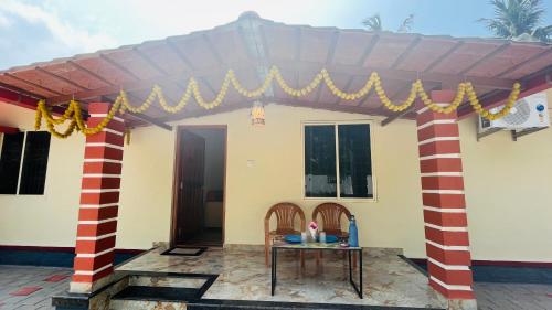 a house with a table in front of it at LX premium cottages - Udupi in Udupi