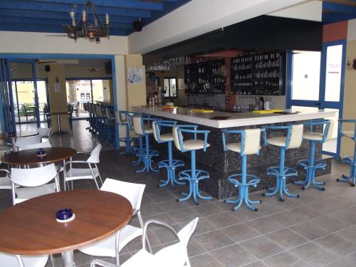 a bar in a restaurant with tables and chairs at Kefalonitis Hotel Apartments in Paphos City
