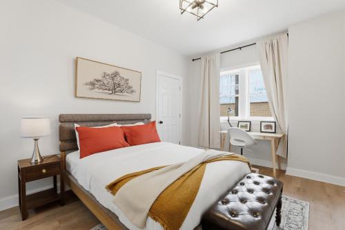 a bedroom with a bed with orange pillows and a chair at Walk to VA DMC 2BR 2 FULL Baths Midtown in Detroit