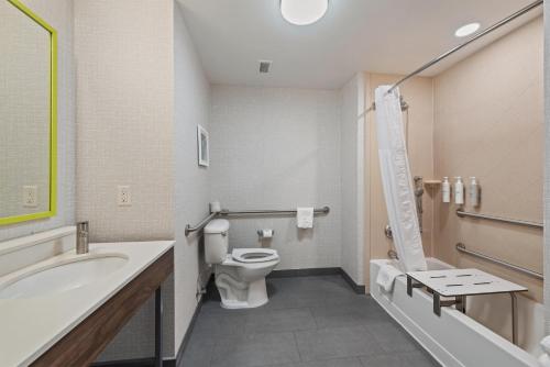 a bathroom with a toilet and a tub and a sink at Hampton Inn La Junta in La Junta