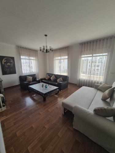 a living room with a couch and a coffee table at appartement Rabat Gare à 3min,Rabat honey house in Rabat