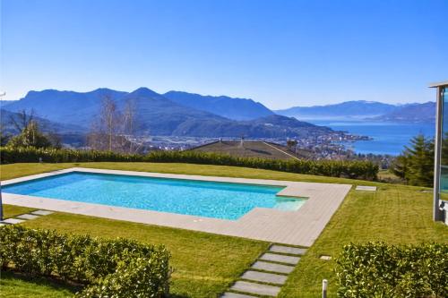 a swimming pool in a yard with a view of the water at Residenza Roggiolo in Luino