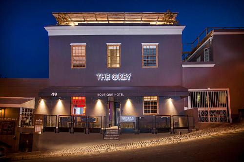 a building with a sign that reads the grey at night at The Grey Hotel in Cape Town
