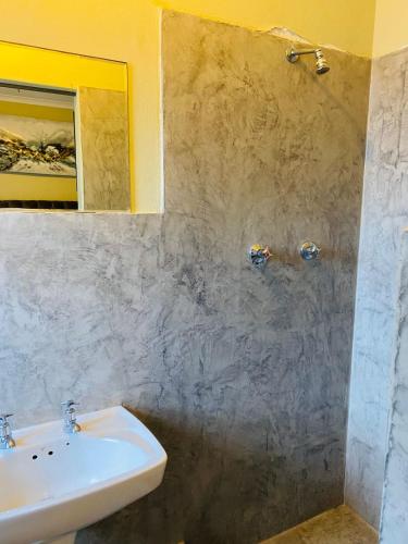 a bathroom with a sink and a mirror at GLOBALNEST guest house in Cape Town
