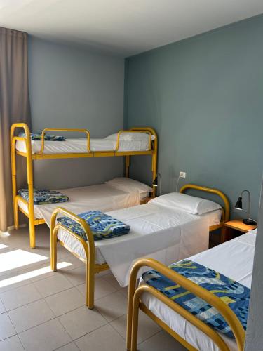 a room with two bunk beds and a window at Ostello Del Porto in Lovere