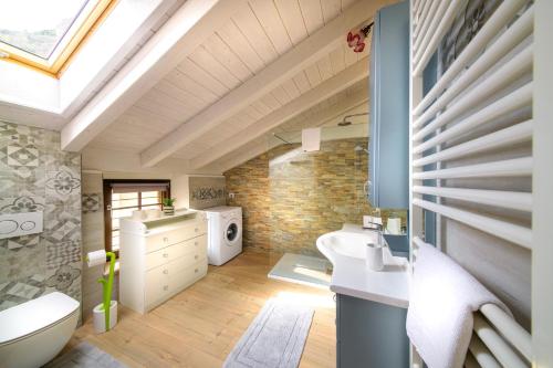 an attic bathroom with a sink and a toilet at Casa Vacanza Nonna Pia I & III in "Piazza Basilica" in Tirano