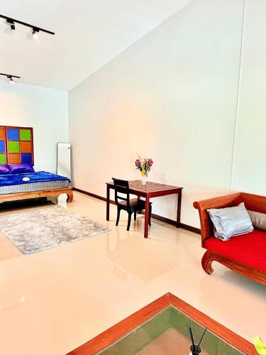 a living room with a couch and a table at Amazing beach apartment Phuket in Phuket
